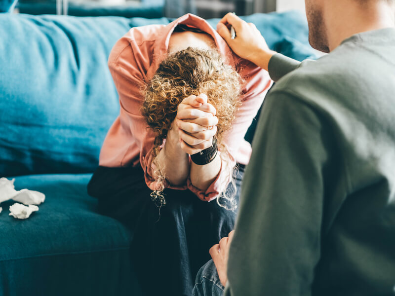 Woman crying on couch